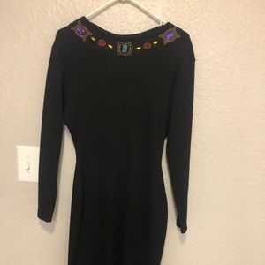 Midy length black dress with studs.